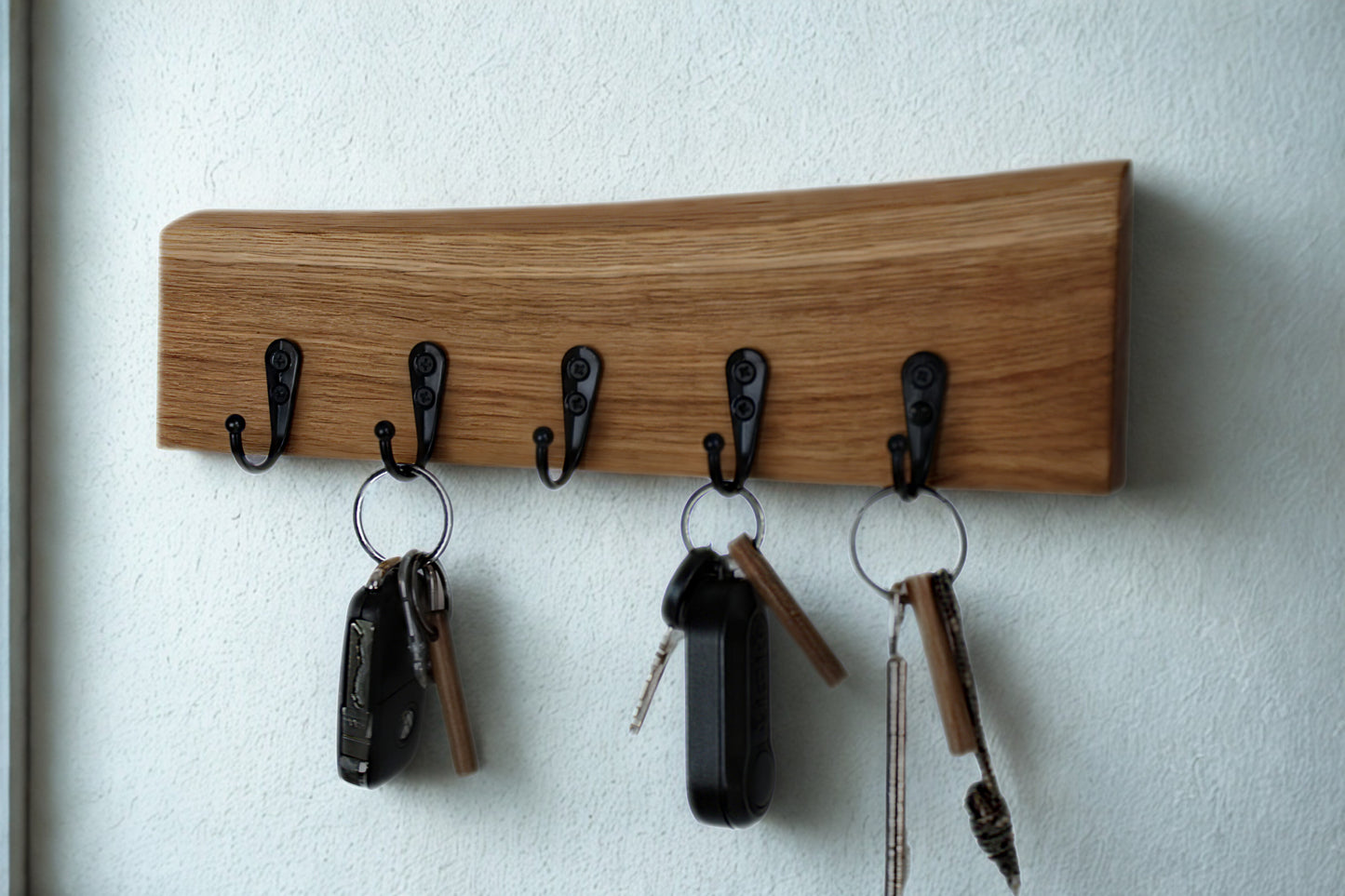 Eichenholz-Schlüsselbrett mit schwarzen Haken und natürlicher Waldkante